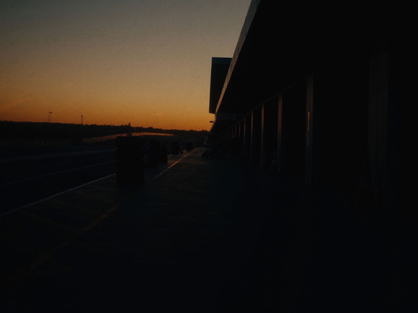 Pit lane with stacked tires at dawn