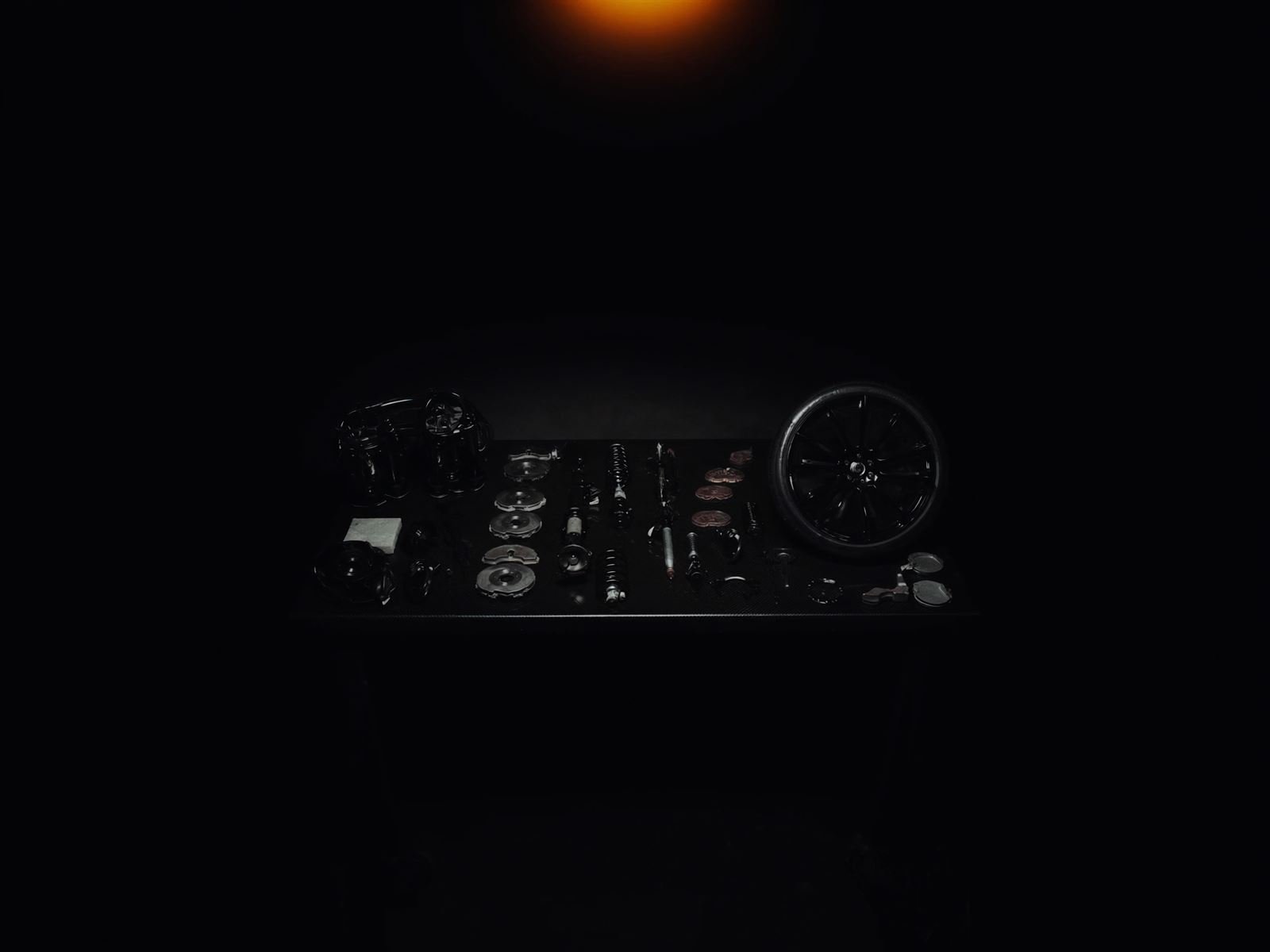 Performance parts laid out on a dark workshop bench