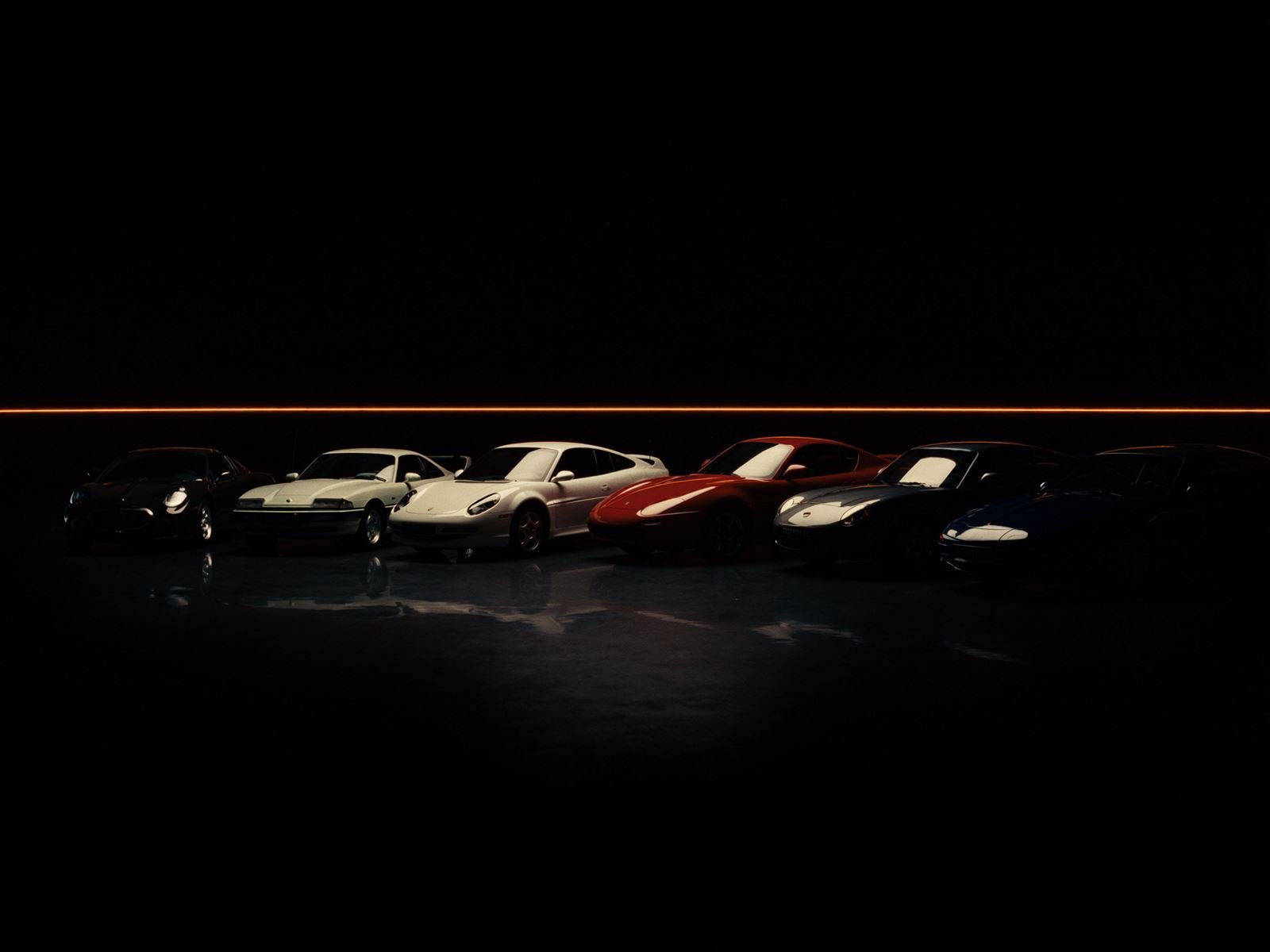 Row of classic sports cars edge-lit in a dark showroom